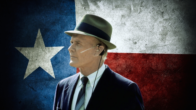 Tom Landry, Wearing a Fedora, Standing in Front of The Texas State Flag