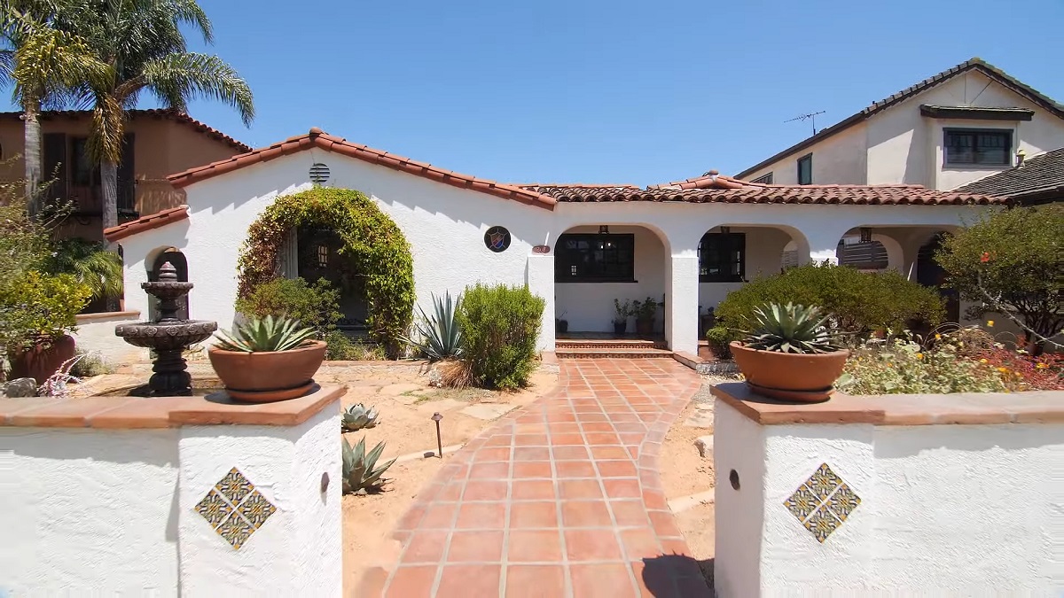 A charming Spanish-style house with white stucco walls, terracotta roof tiles