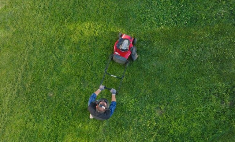 Birdseye view of a person mowing a lawn
