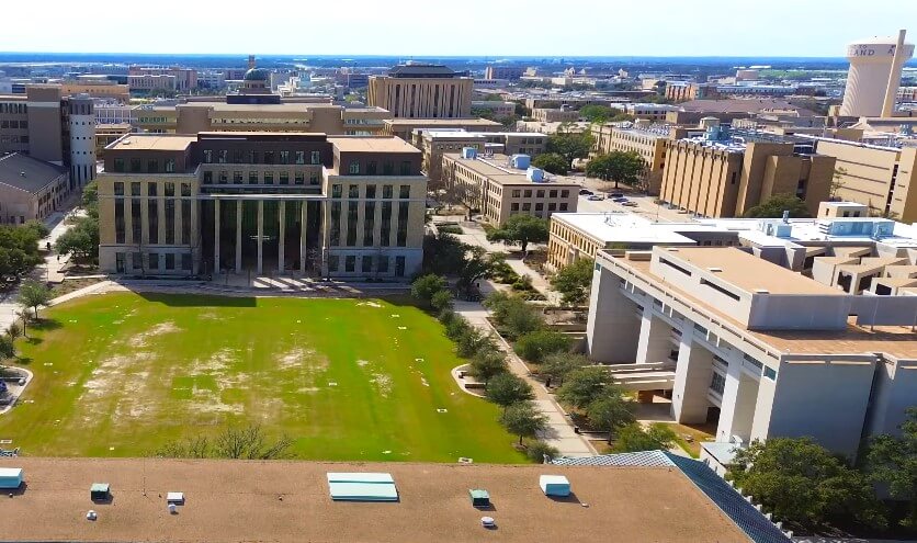 Sprawling campus, encompassing various academic buildings and a central grassy area