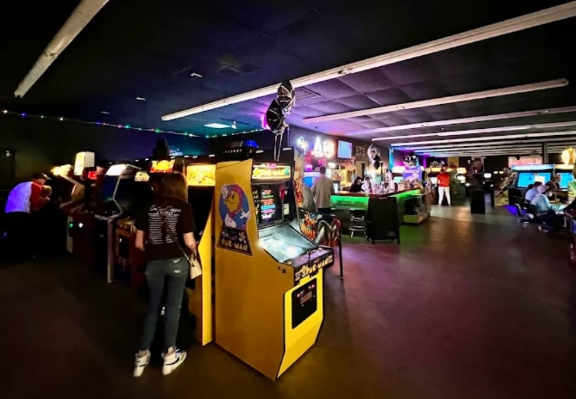 Vintage arcade games and bar area at Electric Starship