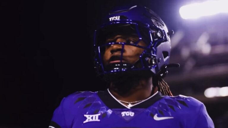 Focused athlete in a deep purple uniform, ready for action