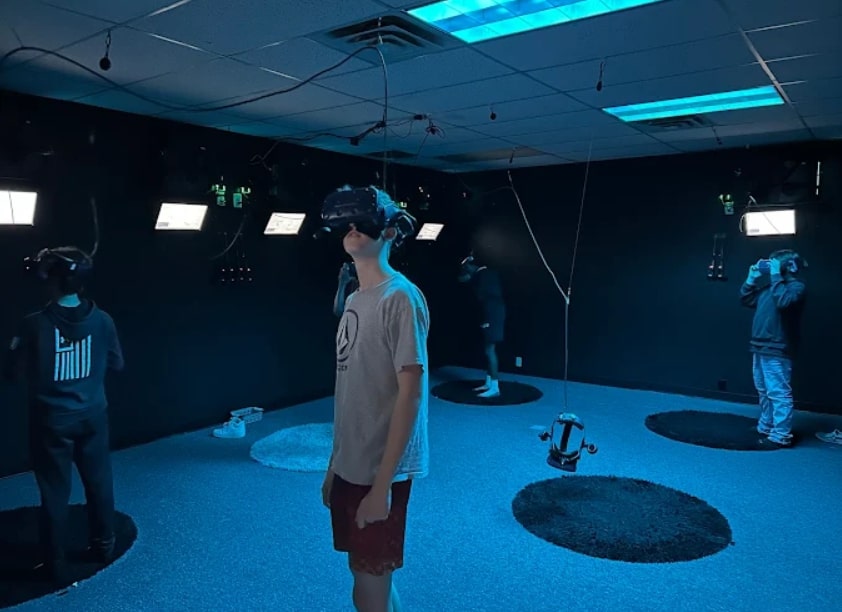 Teens immersed in VR gaming at Virtropolis VR lounge