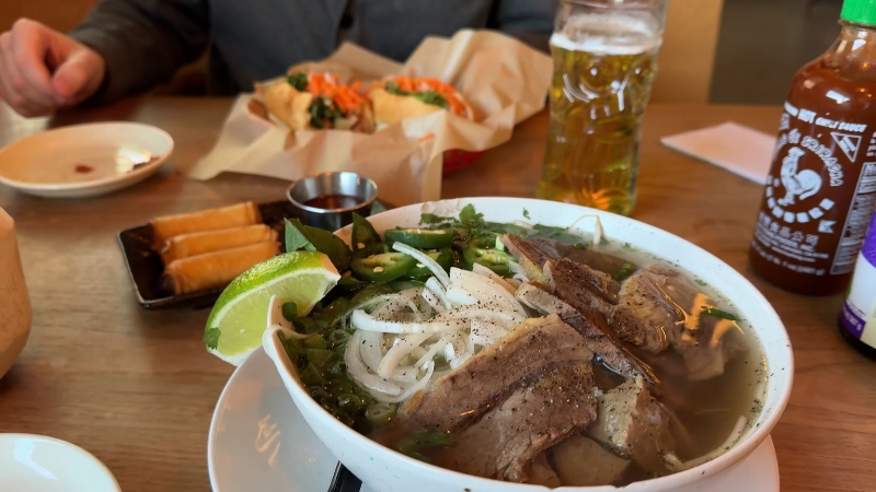 Bowl of beef pho on a table at an Austin restaurant during a casual meal