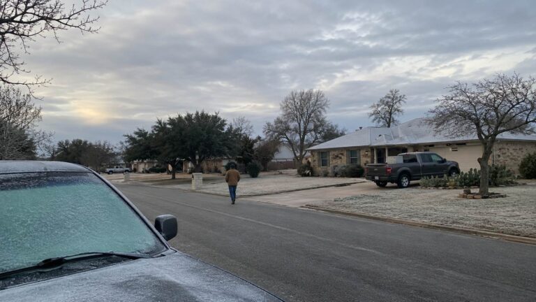 Frost-covered car and homes on a cold Texas morning